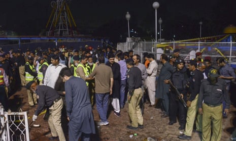 Pakistan rescue workers and police gather at a park where a suicide bomber killed scores in a crowded park in Lahore.