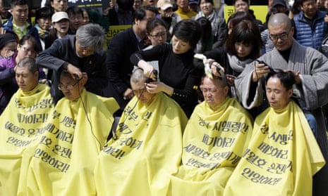 Ferry disaster families shave their heads in protest