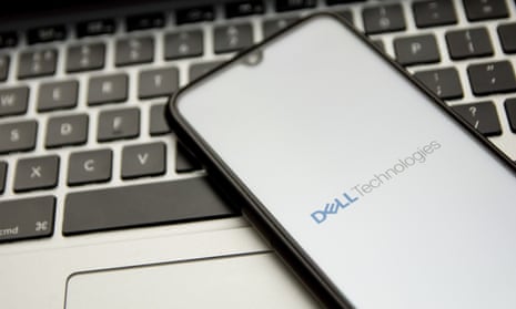 Dell logo on smartphone on top of laptop keyboard