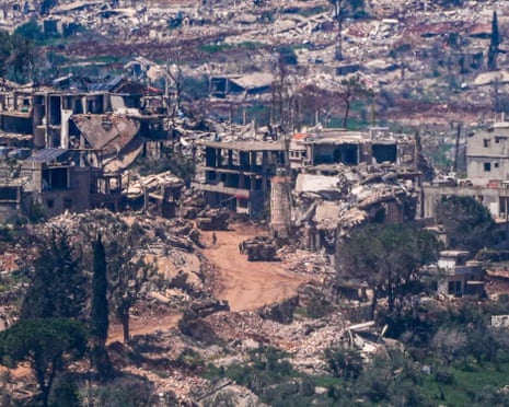 Israeli military vehicles and soldiers in a village in southern Lebanon as the Israeli army operates, as seen from the Israeli side of the border