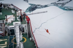 Members of the expedition team on board the SA Agulhas II as it breaks through ice