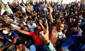 Sudanese demonstrators cheering at the protest rally.