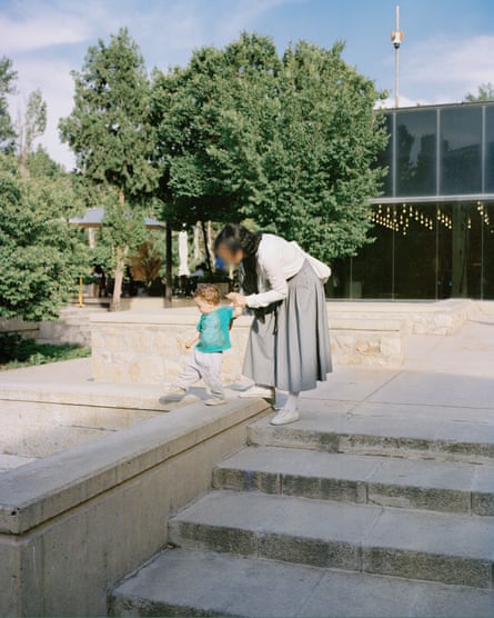A woman strolls with her child around the Tehran Museum of Contemporary Art