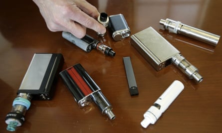 A high school principal in Massachusetts displays vaping devices that were confiscated from students in 2018.
