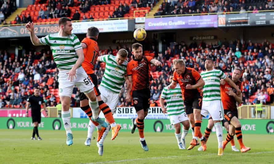 Celtic’s Carl Starfelt goes up for a header with Dundee United’s Scott McMann.
