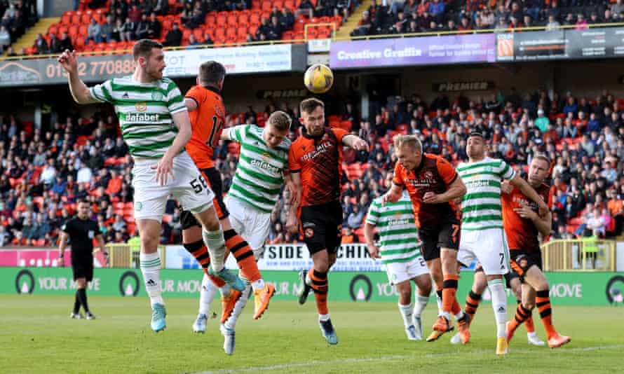 Celtic’s Carl Starfelt goes up for a header with Dundee United’s Scott McMann.