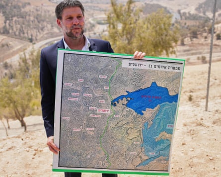 Israel’s finance minister, Bezalel Smotrich, holds a map showing the E1 settlement project