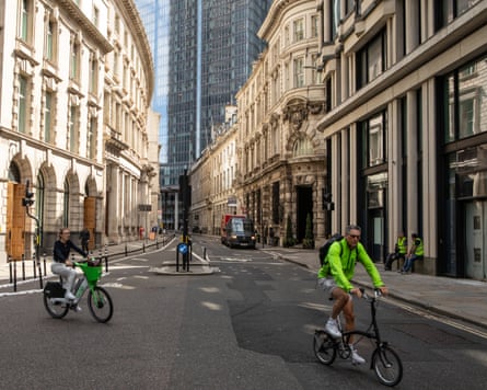 Cyclists on Threadneedle Street on a quiet Friday morning in the City of London.