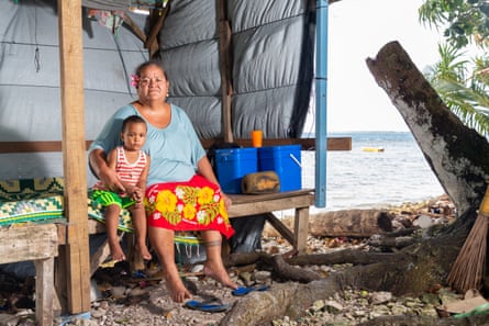 Nasaleta Setani, 54, with her nephew in a makeshift structure near the Funafuti lagoon, which they use for sleeping