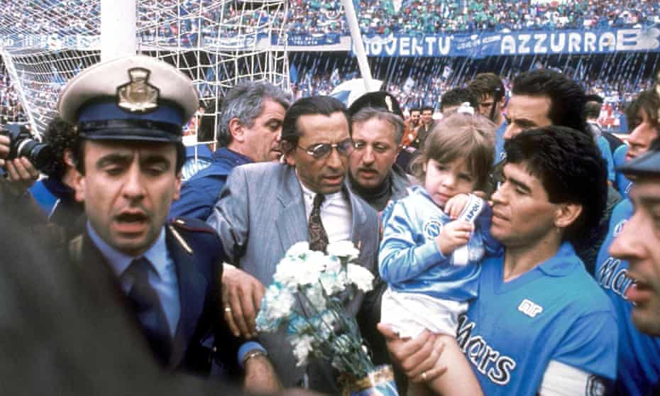 Diego Maradona and his daughter Dalma are surrounded after Napoli won their first Serie A title in 1987