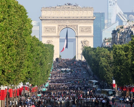 Troops get ready for the annual Bastille Day military parade on the Champs-Elysees Avenue with the Arc de Triomphe in the background in Paris.