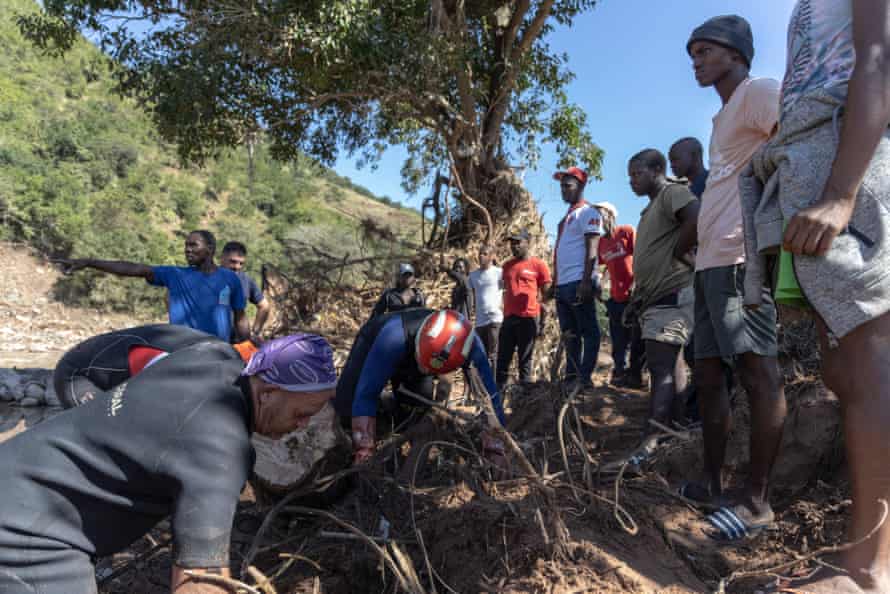 The father of a missing man looks with community members and members of a search and rescue unit in KwaNdengezi, west of Durban.