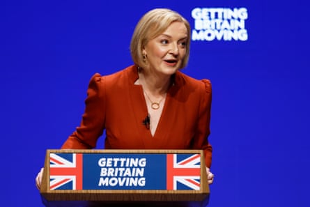 Truss in red outfit at podium