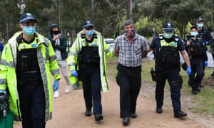 A man is detained during a planned anti-lockdown protest in Melbourne on Saturday.