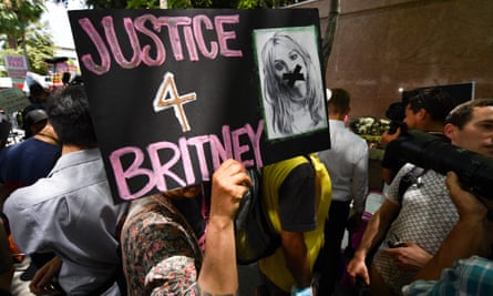 A fan holds a poster of Britney with her mouth taped shut as supporters gather outside the Los Angeles county courthouse in Los Angeles earlier this month.