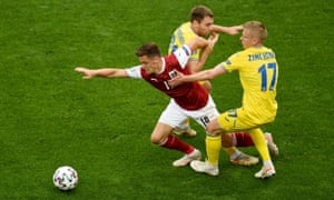 Austria’s Christoph Baumgartner attempts to get free of the challenge of Ukraine’s Oleksandr Karavaev (centre) and Oleksandr Zinchenko.