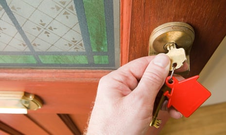 A person opens a door using a key