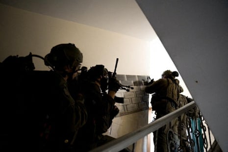 A handout photo issued by the Israel Defense Forces shows Israeli soldiers operating at an undisclosed location inside the Gaza Strip.