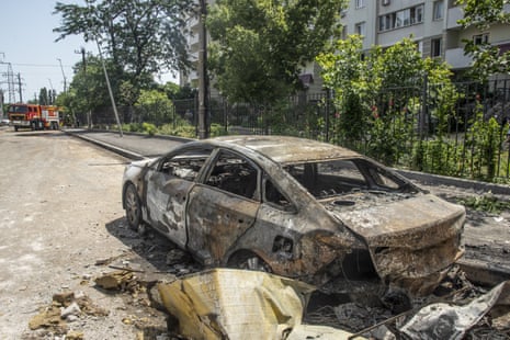 A view of the damaged area as officials conduct debris removal work and battling to put out flames following a Russian missile attack hitting a big civil warehouse in Odesa, Ukraine on June 24.