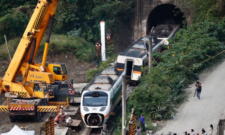 Rescuers remove parts of the train which derailed in a tunnel north of Hualien County, eastern Taiwan.