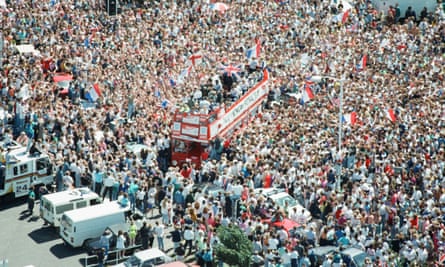 Thousands of England football fans line the streets near Luton airport to welcome the England football team back from Italy, following the World Cup tournament. They were eliminated in the semi-finals by West Germany. 8th July 1990.