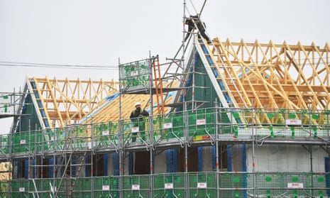 Builders work on a £7.8m housing estate by construction company Seddon, in Burslem, England