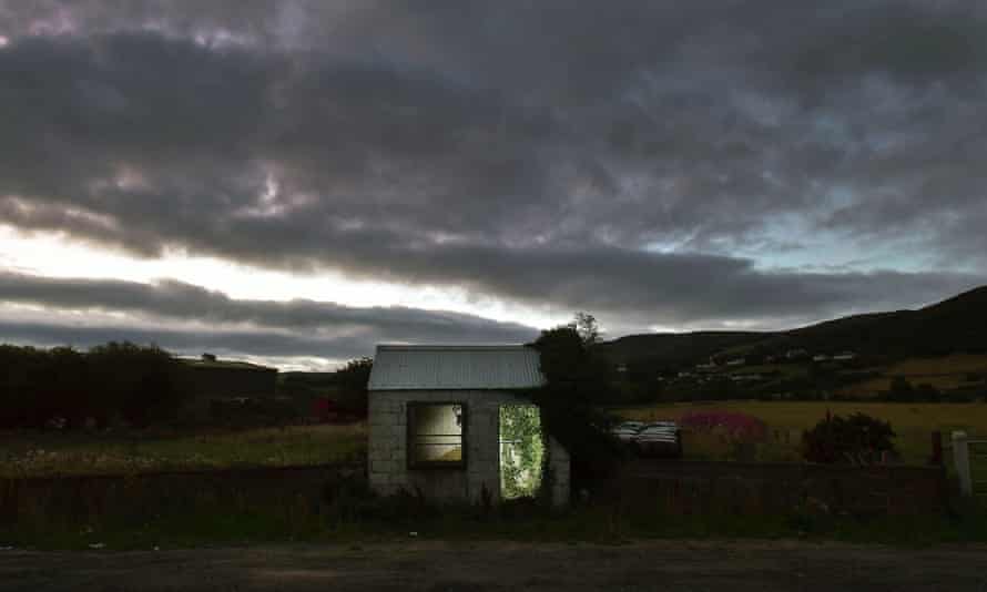 A former customs guard hut is illuminated on the Irish border in Ravensdale, Ireland.