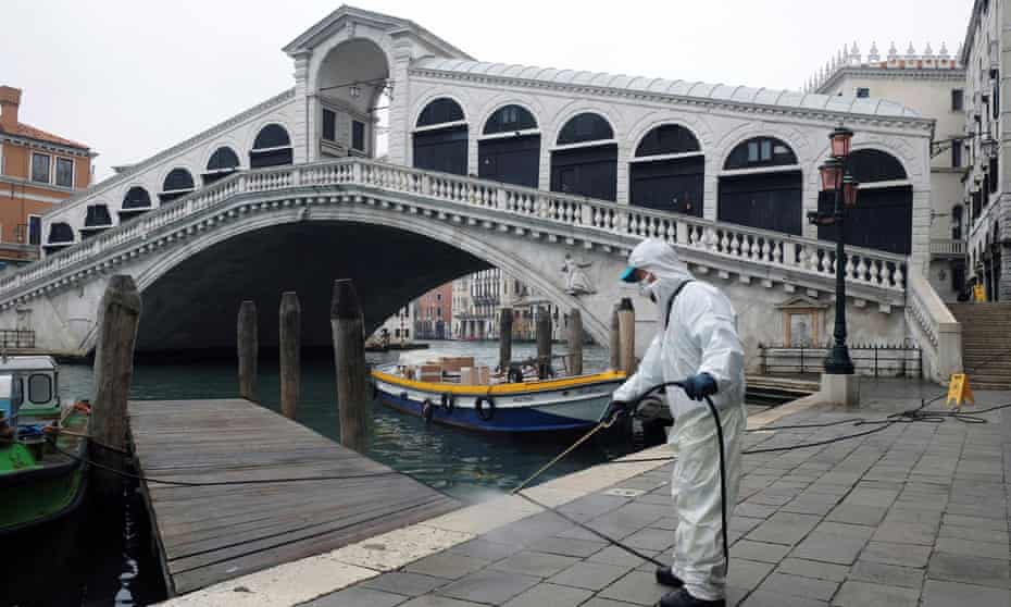 A worker sanitises the Rialto Bridge on 13 March. 