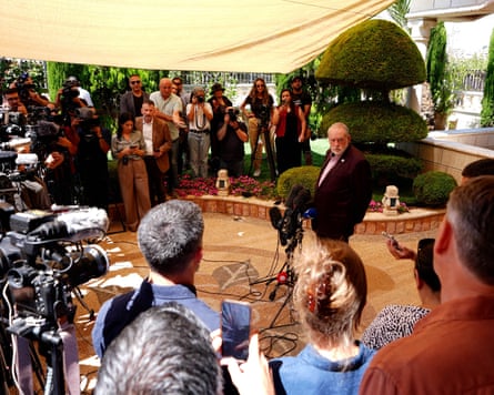 Mike Huckabee stands in front of a crowd of journalists with cameras Mike Huckabee stands in front of a crowd of journalists with cameras