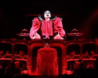 Lady Gaga on stage in a giant red gown