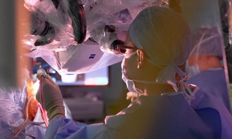 An NHS brain tumour surgeon performs an operation.