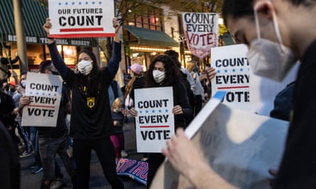 People dance and hold signs during a protest in support of counting all votes in Philadelphia, Pennsylvania, on 5 November.