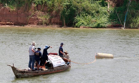 Divers search for an aircraft bomb during a diving operation in the Mekong river in Kandal province, Cambodia.