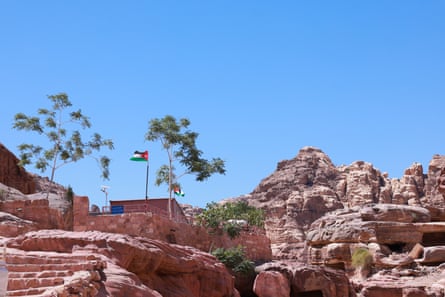 Two flags flying in a rocky landscape