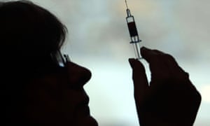 A nurse preparing to give a patient a vaccine