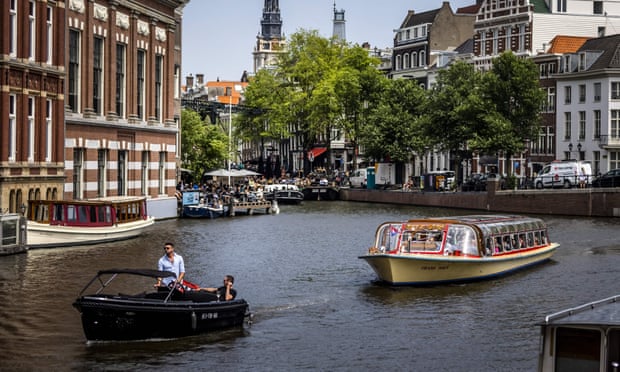 Tourists take a trip along a canal in Amsterdam, where the mayor is warning of a ‘culture of crime and violence’.  