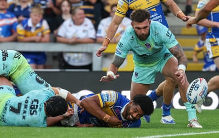 Leeds Rhinos’ Kallum Watkins drops the ball as he is tackled by the St Helens defence