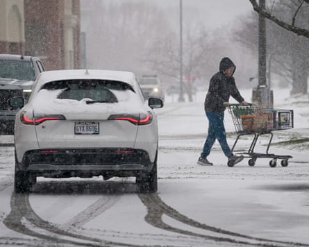 A shopper walks through a snow-covered parking lot in Brentwood, Tennessee.