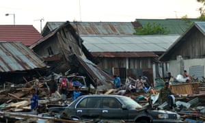 Residents trying to salvage belongings from their homes which collapsed after an earthquake and tsunami hit Palu on Sulawesi island.