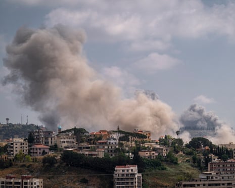 Smoke rises over hilltop town