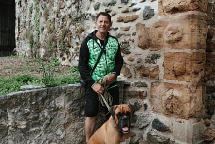 Bernie, resident of the village Colombier-Saugnieu, with his bull mastiff dog Sherlock.