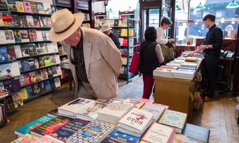 A customer examines the hardbacks in Daunt Books, central London