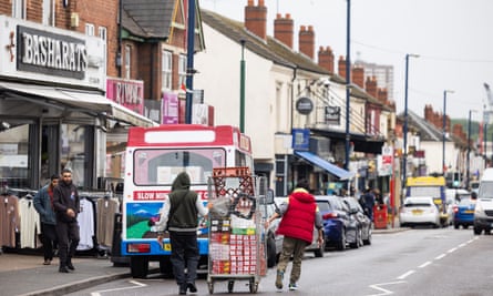 A general view of Alum Rock Road, a shows traffic and people moving goods