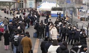 People wait for their coronavirus test at a makeshift testing site in Seoul, South Korea, Monday, Feb. 14, 2022.