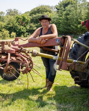 Daniel Colbourne, who plants crops and runs a duck farm with Rachel Stevens, poses in his field and land close to Fishguard, West Wales.