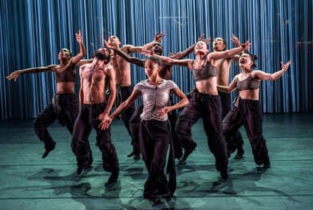 Hannah Joseph stands centre as dancers reach and gesture dramatically in Tellus