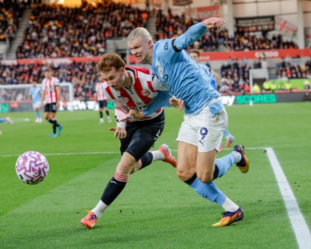 Brentford’s Sepp van den Berg battles with Erling Haaland