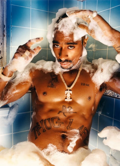 Tupac Shakur, naked in a bath, with soap bubbles all around him