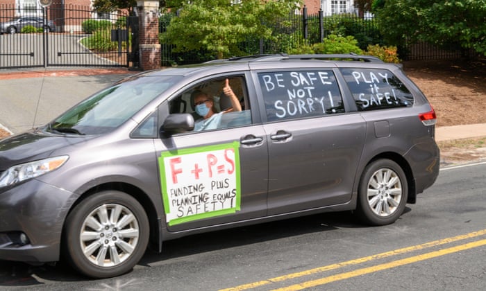A vehicle participating in the ‘School Safety First’ car caravan passes the governor’s Ned Lamont’s home in Hartford Connecticut.