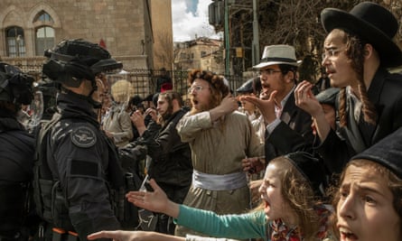 Men clash with police in Jerusalem during a protest to end the military exemption of ultra-Orthodox students.